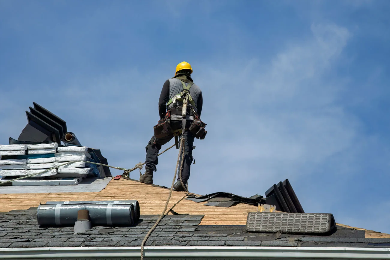 Roofing contractor completing an asphalt shingle roof replacement in Farmington MN